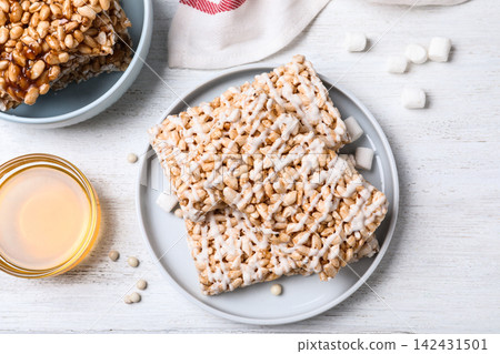 Delicious rice crispy treats on white wooden table, flat lay Delicious rice crispy treats on white wooden table, flat lay 142431501