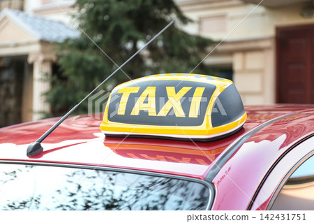 Roof light with word TAXI on car outdoors Roof light with word TAXI on car outdoors 142431751