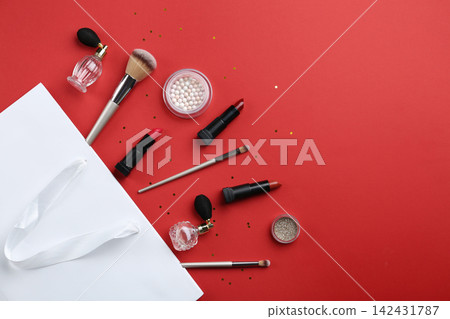 Flat lay composition with cosmetics and space for text on red background Flat lay composition with cosmetics and space for text on red background 142431787