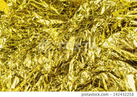 Crumpled gold foil texture background with shiny metallic wrinkles and reflective creases. Holiday, celebration or texture background Crumpled gold foil texture background with shiny metallic wrinkles and reflective creases. Holiday, celebration or texture background 142432258