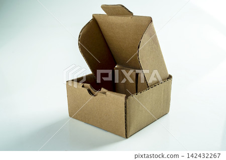 An open brown corrugated cardboard box on a white background, perfect for e-commerce, shipping, and packaging mockup concepts. Mockup or Copyspace An open brown corrugated cardboard box on a white background, perfect for e-commerce, shipping, and packaging mockup concepts. Mockup or Copyspace 142432267