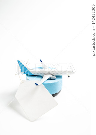 A model airplane on a blue foam block with a blank white tag, isolated on a white background. Ideal for travel, sales, and booking concepts. Mockup or Copyspace A model airplane on a blue foam block with a blank white tag, isolated on a white background. Ideal for travel, sales, and booking concepts. Mockup or Copyspace 142432309