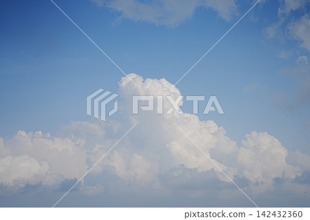 Large summer cumulonimbus clouds spread across the blue sky. Large summer cumulonimbus clouds spread across the blue sky. 142432360