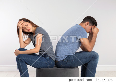 Couple with relationship problems on light background Couple with relationship problems on light background 142432420