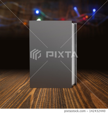 Blank dark gray hardcover book mockup standing upright on a wooden surface with a blurred bokeh background. Study or education concept Blank dark gray hardcover book mockup standing upright on a wooden surface with a blurred bokeh background. Study or education concept 142432440