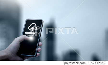 Hand holding smartphone showing cloud upload progress against blurry city background, symbolizing mobile backup and data storage. Concept of cloud computing storage and digital storage technology Hand holding smartphone showing cloud upload progress against blurry city background, symbolizing mobile backup and data storage. Concept of cloud computing storage and digital storage technology 142432452