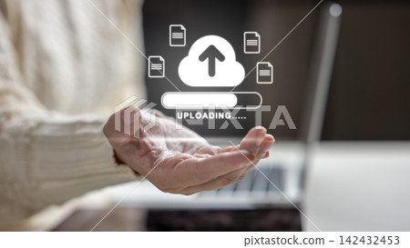Female hand holding a holographic cloud upload icon with file symbols and a progress bar above a laptop. Concept of cloud computing storage and digital storage technology Female hand holding a holographic cloud upload icon with file symbols and a progress bar above a laptop. Concept of cloud computing storage and digital storage technology 142432453