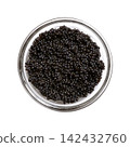 Black caviar made from lumpfish roe, in a glass bowl, isolated from above. Affordable, small, deep black dyed, salted fish eggs from Cyclopterus lumpus, also called lumpsucker, used as garnish. Photo Black caviar made from lumpfish roe, in a glass bowl, isolated from above. Affordable, small, deep black dyed, salted fish eggs from Cyclopterus lumpus, also called lumpsucker, used as garnish. Photo 142432760