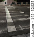 Braille blocks and faded pedestrian crossing 142432825