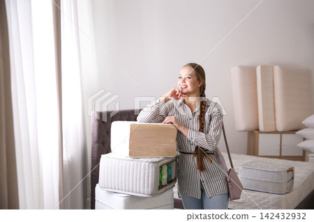 Young woman choosing mattress in furniture store Young woman choosing mattress in furniture store 142432932
