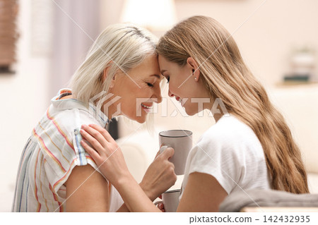 Mother and her adult daughter spending time together at home Mother and her adult daughter spending time together at home 142432935