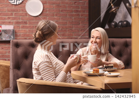 Mother and her adult daughter spending time together in cafe 142432945