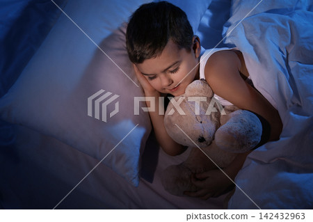 Little boy sleeping with teddy bear at home. Bedtime Little boy sleeping with teddy bear at home. Bedtime 142432963