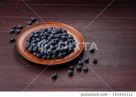 Fresh, ripe, and juicy wild blueberries as an ingredient for vegetarian dishes Fresh, ripe, and juicy wild blueberries as an ingredient for vegetarian dishes 142433112