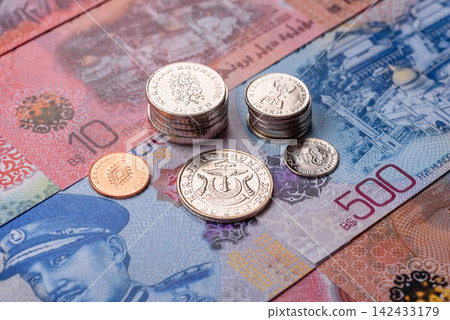 Brunei paper money, dollar banknotes and sen coins as currency for exchange or travel. Brunei money Brunei paper money, dollar banknotes and sen coins as currency for exchange or travel. Brunei money 142433179
