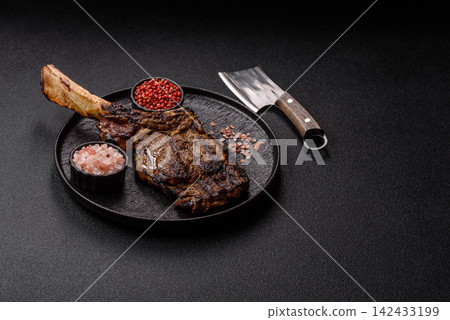 Grilled beef Tomahawk steak seasoned with salt and spices. Tomahawk steak Grilled beef Tomahawk steak seasoned with salt and spices. Tomahawk steak 142433199