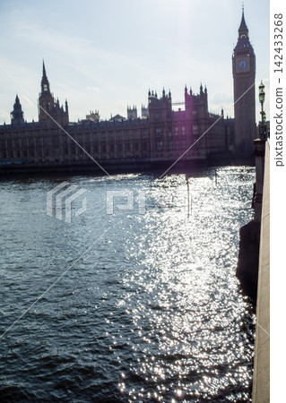 Westminster Palace in the heart of London, bathed in the dazzling backlight of the Thames River. Westminster Palace in the heart of London, bathed in the dazzling backlight of the Thames River. 142433268
