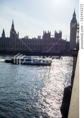 Westminster Palace in the heart of London, bathed in the dazzling backlight of the Thames River. Westminster Palace in the heart of London, bathed in the dazzling backlight of the Thames River. 142433272