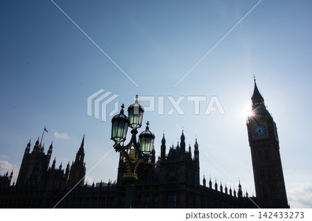 Westminster Palace in the heart of London, bathed in the dazzling backlight of the Thames River. Westminster Palace in the heart of London, bathed in the dazzling backlight of the Thames River. 142433273
