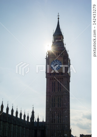 Westminster Palace in the heart of London, bathed in the dazzling backlight of the Thames River. Westminster Palace in the heart of London, bathed in the dazzling backlight of the Thames River. 142433279