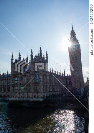 Westminster Palace in the heart of London, bathed in the dazzling backlight of the Thames River. Westminster Palace in the heart of London, bathed in the dazzling backlight of the Thames River. 142433299