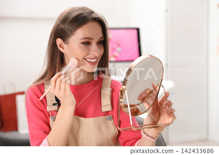 Woman holding cup of delicious hot cocoa with marshmallows at white table indoors, closeup Woman holding cup of delicious hot cocoa with marshmallows at white table indoors, closeup 142433686