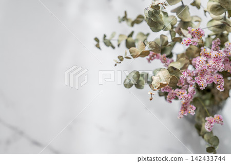 Delicate Pink Dried Flowers and Eucalyptus Branches on marble Background Delicate Pink Dried Flowers and Eucalyptus Branches on marble Background 142433744
