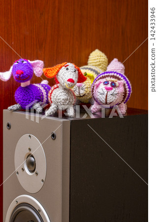Various knitted woolen toys on a speaker. Various knitted woolen toys on a speaker. 142433946