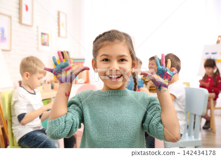 Cute little child with painted palms in room Cute little child with painted palms in room 142434178