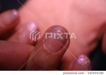 Close-Up Glitter Nail Polish on Fingertips Close-Up Glitter Nail Polish on Fingertips 142434190