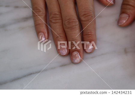 Gleaming Nails on Marble Surface Gleaming Nails on Marble Surface 142434231