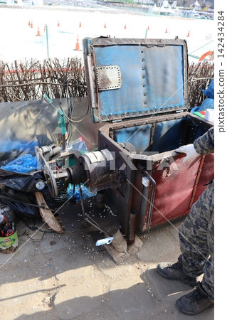 Industrial Worker Operating Machinery on Construction Site 142434284