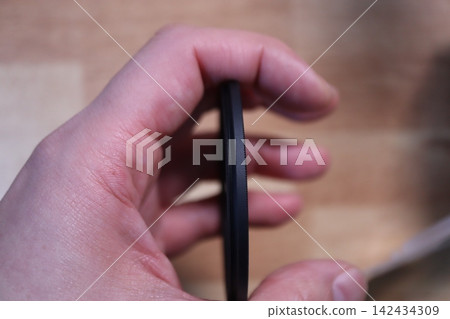 Hand Holding Camera Lens Filter Close-up Hand Holding Camera Lens Filter Close-up 142434309