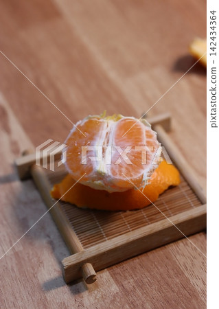 Peeled Orange on Bamboo Tray Close-up Peeled Orange on Bamboo Tray Close-up 142434364