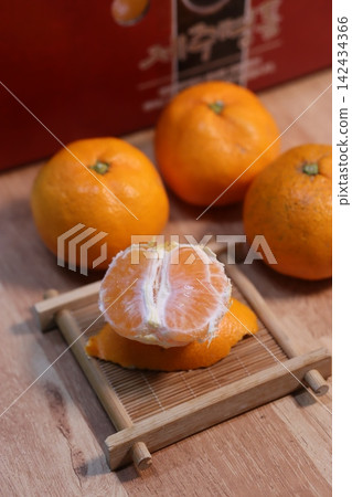 Fresh Oranges and Peeled Mandarin on Wooden Tray Fresh Oranges and Peeled Mandarin on Wooden Tray 142434366