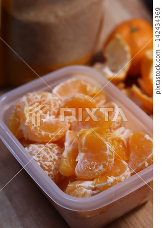 Peeled Mandarin Oranges in Plastic Container 142434369