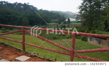Rural hillside landscape with red wooden fence Rural hillside landscape with red wooden fence 142434471