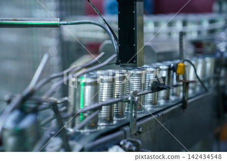 Rows of metal cans on automated production line in food processing plant Rows of metal cans on automated production line in food processing plant 142434548