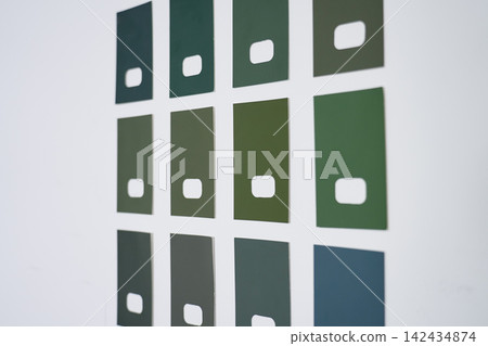 Green paint samples in different shades arranged on white wall Green paint samples in different shades arranged on white wall 142434874