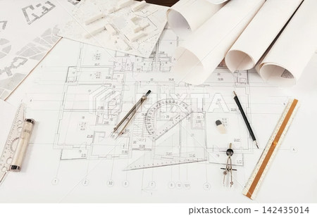 Architectural blueprints and drawings on a desk Architectural blueprints and drawings on a desk 142435014