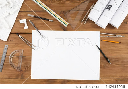 Architectural model with blueprints and drawing tools on wood 142435036