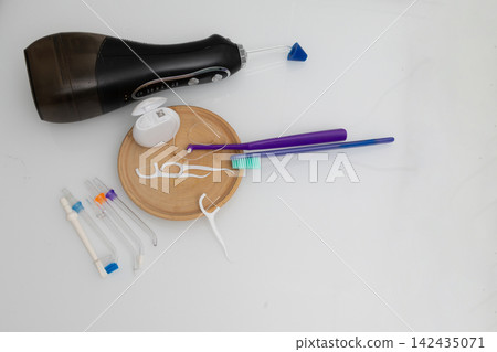 Dental care items on a clean bathroom countertop for at-home oral hygiene Dental care items on a clean bathroom countertop for at-home oral hygiene 142435071