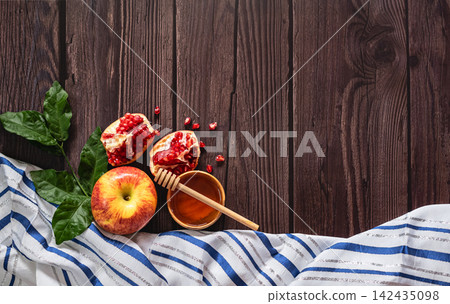 Rosh Hashanah Jewish New Year holiday with pomegranate, apples, honey on the wooden background Rosh Hashanah Jewish New Year holiday with pomegranate, apples, honey on the wooden background 142435098