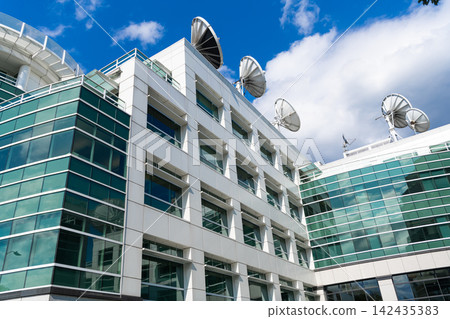 Architectural design of building with satellite dish. Residential building architecture. Architectural exterior. Residential glass exterior fragment. Modern residential building. Glass building Architectural design of building with satellite dish. Residential building architecture. Architectural exterior. Residential glass exterior fragment. Modern residential building. Glass building 142435383