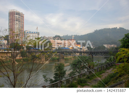 Standing in Lao Cai, northern Vietnam, looking across the Nam Thi River to Hekou in China 142435887