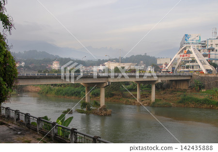 Standing in Lao Cai, northern Vietnam, looking across the Nam Thi River to Hekou in China Standing in Lao Cai, northern Vietnam, looking across the Nam Thi River to Hekou in China 142435888