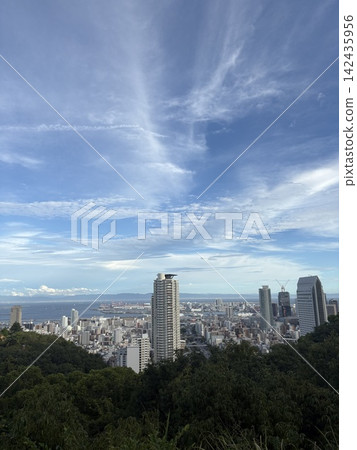 A view of the cityscape and blue sky from afar. A view of the cityscape and blue sky from afar. 142435956