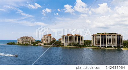 Aerial night view of Miami coastline. Twilight skyline above the Miami oceanfront. Miami Beach waterfront with dramatic sky. Aerial night view of Miami coastline. Twilight skyline above the Miami oceanfront. Miami Beach waterfront with dramatic sky. 142435964