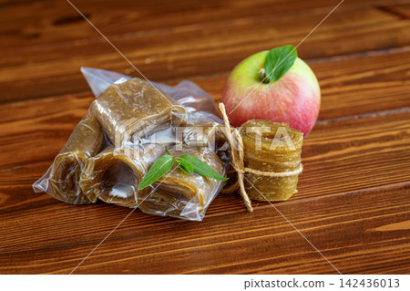 Dried apple pastila in sealed bag on rustic wooden background Dried apple pastila in sealed bag on rustic wooden background 142436013
