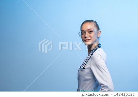 Female doctor wearing protective goggles and stethoscope ready to work Female doctor wearing protective goggles and stethoscope ready to work 142436185